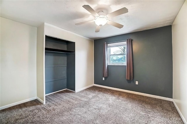 unfurnished bedroom featuring a closet, ceiling fan, and carpet