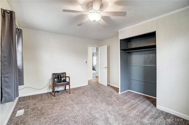 unfurnished bedroom with ceiling fan, carpet flooring, and a closet