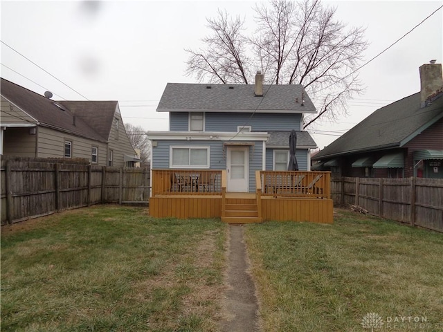 back of property featuring a yard and a deck