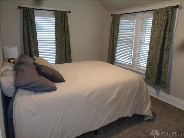 bedroom featuring lofted ceiling and carpet floors