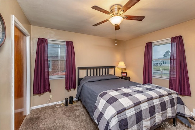 bedroom featuring ceiling fan and carpet