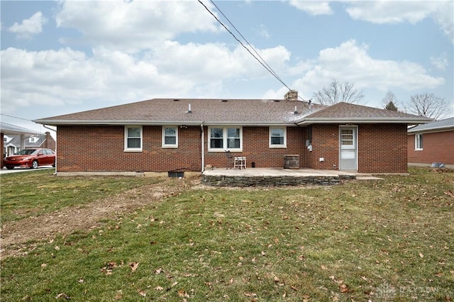 rear view of property featuring a yard and a patio