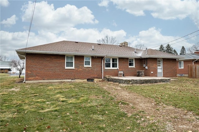 back of house with a patio area and a lawn