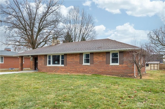 view of front of property with a shed and a front yard