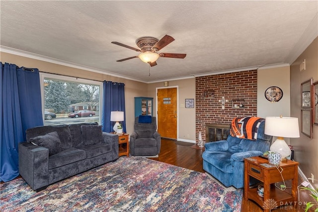 living room featuring ornamental molding, dark hardwood / wood-style floors, a fireplace, and a textured ceiling