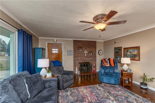 living room featuring crown molding, a brick fireplace, a textured ceiling, dark hardwood / wood-style flooring, and ceiling fan