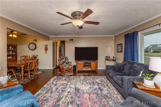 living room featuring ornamental molding, dark hardwood / wood-style floors, ceiling fan, and a textured ceiling