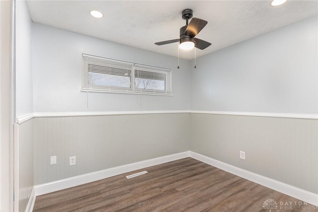 spare room featuring a textured ceiling, wood-type flooring, and ceiling fan