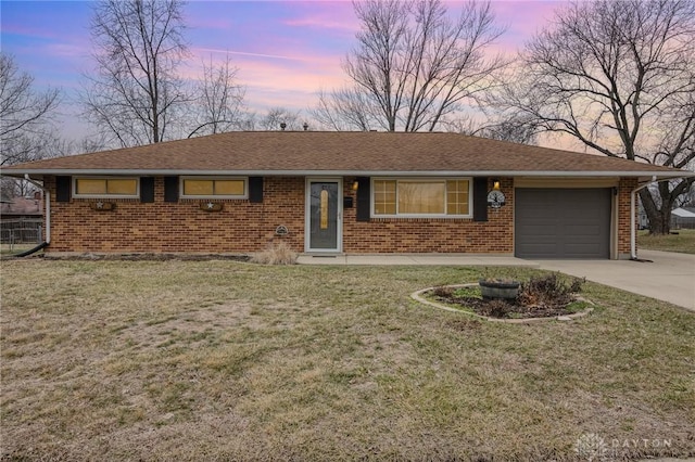 single story home with a garage and a lawn