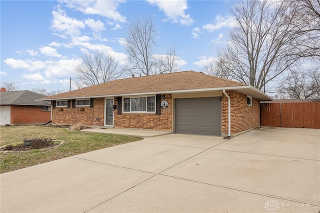 ranch-style home with a garage and a front yard