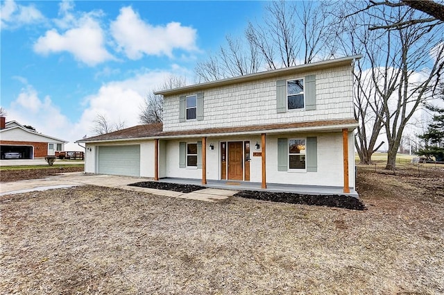 view of property with a garage and a porch