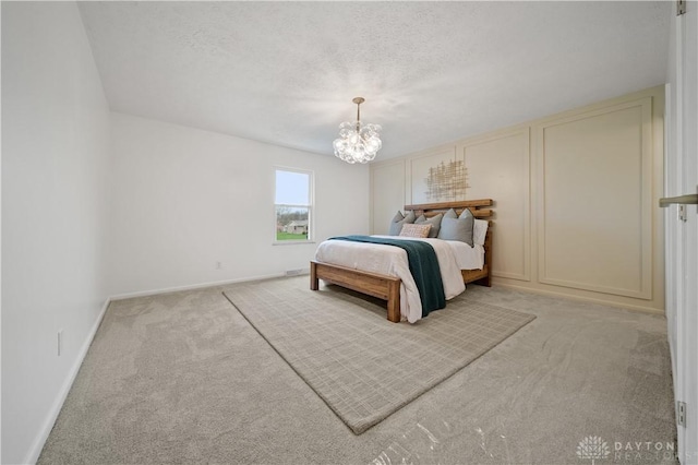 4260 Penny Pike, German Twp, OH 45502 - bedroom featuring light colored carpet, a chandelier, baseboards, and a textured ceiling