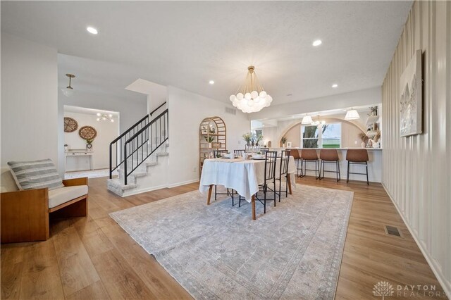 4260 Penny Pike, German Twp, OH 45502 - dining area with a chandelier, wood finished floors, stairway, recessed lighting, and baseboards