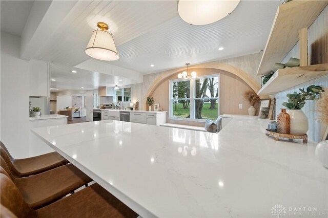 4260 Penny Pike, German Twp, OH 45502 - kitchen with white cabinets, arched walkways, a chandelier, and dishwasher