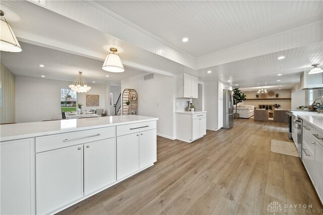 4260 Penny Pike, German Twp, OH 45502 - kitchen featuring open floor plan, white cabinetry, light wood-style flooring, stainless steel appliances, and light countertops