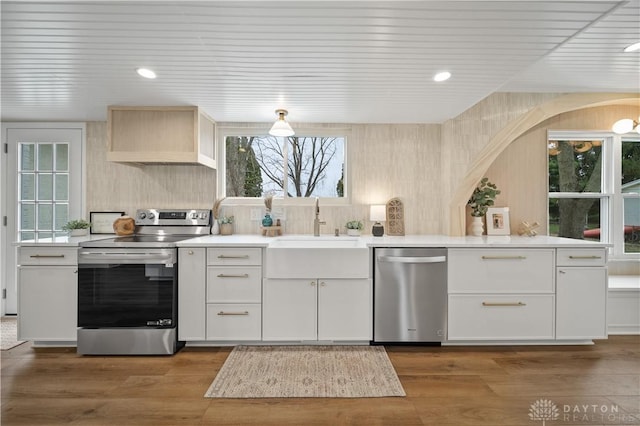 4260 Penny Pike, German Twp, OH 45502 - kitchen featuring stainless steel appliances, light countertops, white cabinetry, dark wood-style floors, and a sink