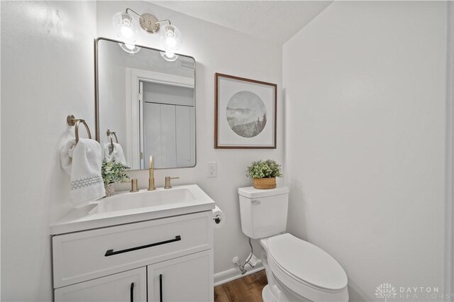4260 Penny Pike, German Twp, OH 45502 - bathroom featuring wood finished floors, toilet, vanity, and baseboards
