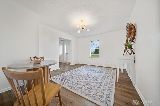 4260 Penny Pike, German Twp, OH 45502 - dining area with a chandelier, dark wood-style floors, and baseboards