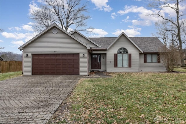 single story home featuring a garage and a front yard