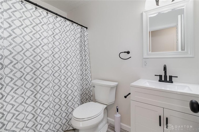 bathroom featuring vanity, toilet, and a shower with shower curtain