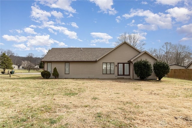 back of property featuring a lawn