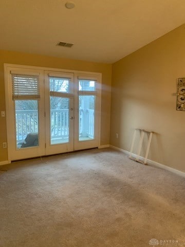 spare room with light colored carpet