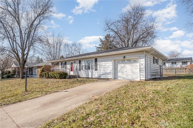 ranch-style house featuring a garage, fence, and a front yard