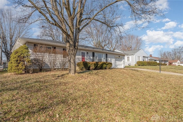 ranch-style home featuring an attached garage and a front yard