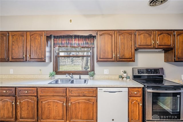 kitchen with light countertops, white dishwasher, a sink, and stainless steel electric stove