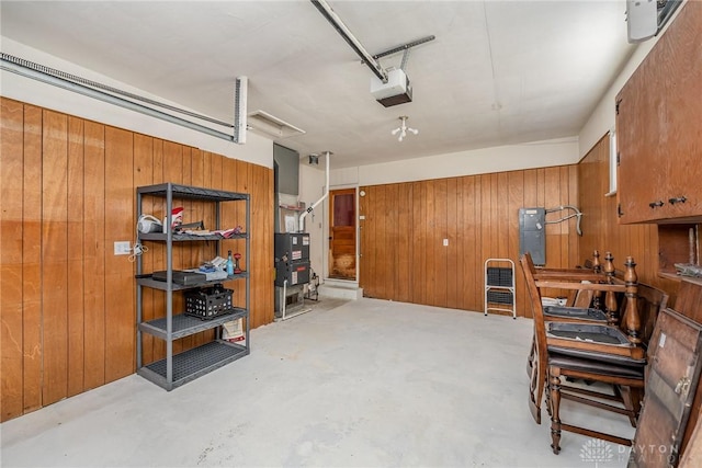 garage with a garage door opener and wooden walls