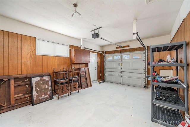 garage featuring wooden walls and a garage door opener