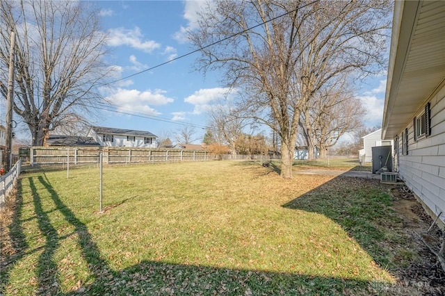 view of yard featuring fence and central AC unit