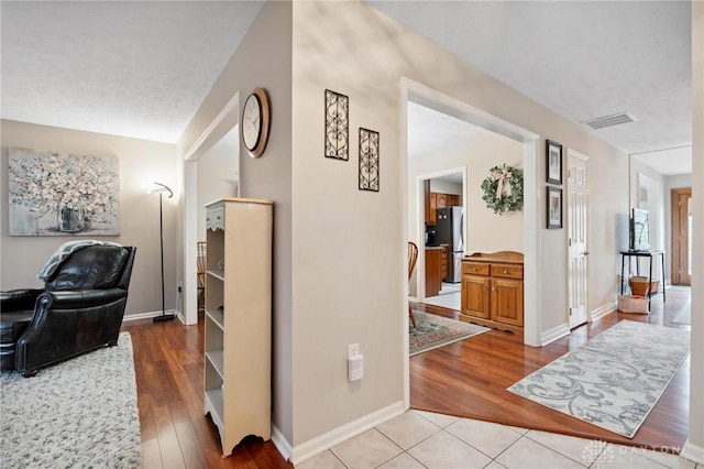 7789 Thomas Jefferson Ln, Centerville, OH 45459 - corridor featuring baseboards, visible vents, and light wood finished floors