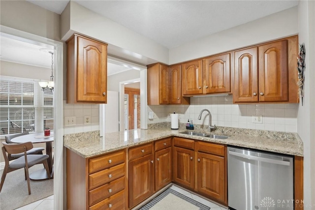 7789 Thomas Jefferson Ln, Centerville, OH 45459 - kitchen with brown cabinetry, a sink, dishwasher, and light tile patterned flooring
