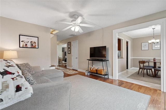 7789 Thomas Jefferson Ln, Centerville, OH 45459 - living room featuring baseboards, wood finished floors, and ceiling fan with notable chandelier