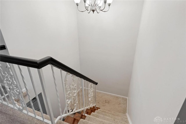 7789 Thomas Jefferson Ln, Centerville, OH 45459 - stairs with an inviting chandelier, carpet floors, and baseboards
