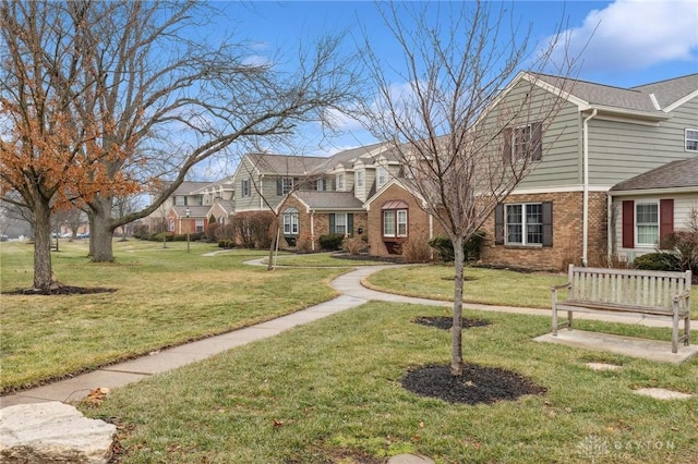 7789 Thomas Jefferson Ln, Centerville, OH 45459 - traditional-style home with a residential view, a front yard, and brick siding