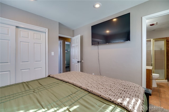 unfurnished bedroom with tile patterned floors, ensuite bath, and a closet