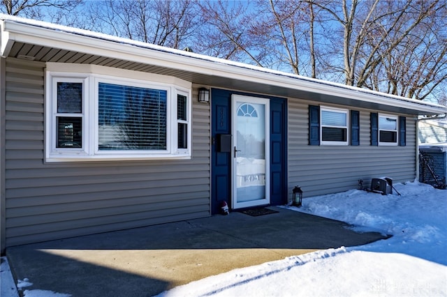 view of snow covered property entrance