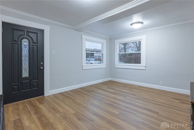 entrance foyer with crown molding, light hardwood / wood-style floors, and a textured ceiling