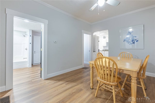 dining area featuring crown molding, ceiling fan, and light hardwood / wood-style flooring