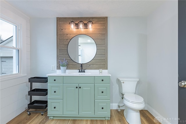 bathroom featuring vanity, hardwood / wood-style floors, and toilet