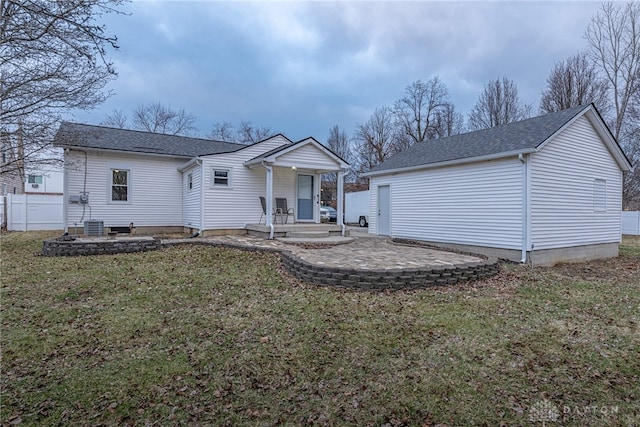 view of front of property with central AC unit, a front yard, and a patio