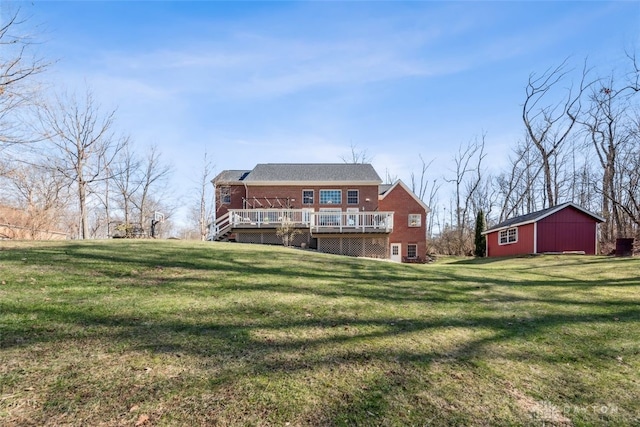rear view of house featuring a lawn, brick siding, and a wooden deck