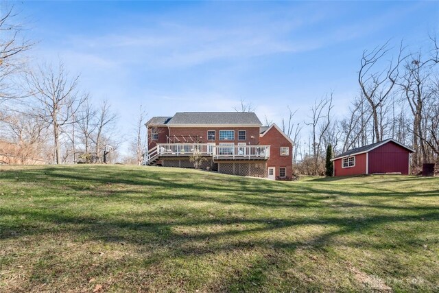 2769 Golden Fox Trl, Lebanon, OH 45036 - rear view of house featuring a lawn, brick siding, and a wooden deck