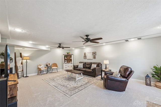 carpeted living room with recessed lighting, a textured ceiling, ceiling fan, and baseboards
