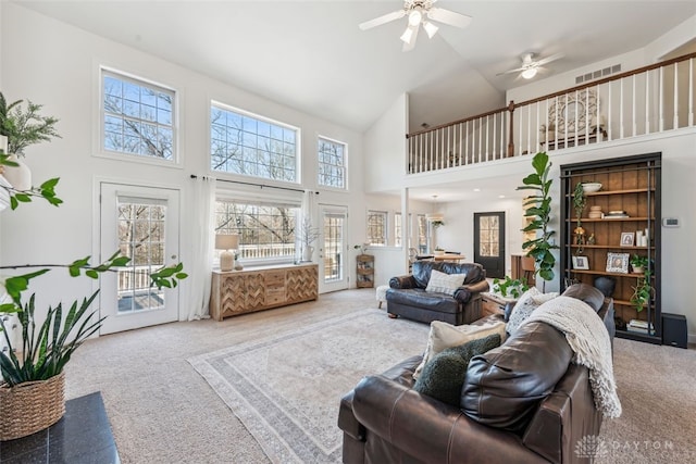 2769 Golden Fox Trl, Lebanon, OH 45036 - carpeted living area with a ceiling fan, high vaulted ceiling, visible vents, and a healthy amount of sunlight
