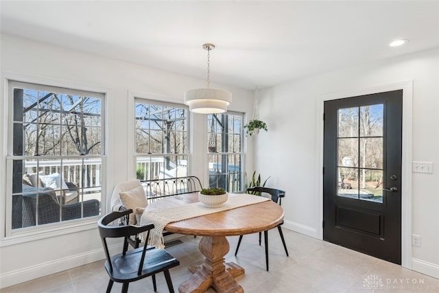 dining room with baseboards, breakfast area, plenty of natural light, and light tile patterned floors