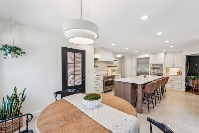 dining room featuring light tile patterned floors, baseboards, and recessed lighting