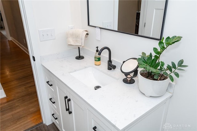 bathroom with vanity and wood-type flooring